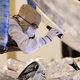 Archival image from February 2021, showing a Northrop Grumman technician inspecting the folding and packing of the Webb Space Telescope’s sunshield.